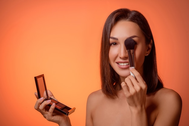 portrait woman applying make up