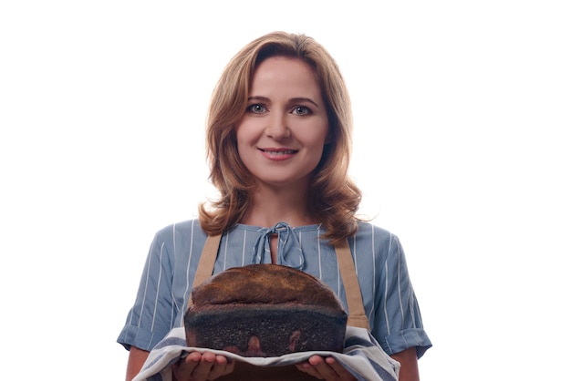 Photo portrait of woman in apron showing a sourdough homemade bread isolated on white background