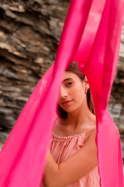 Portrait of woman at the beach hiding her face behind veil