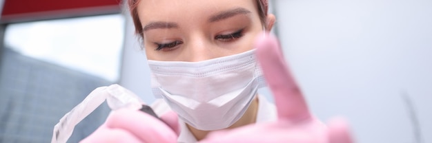 Portrait of woman beautician in protective medical mask customer service in coronavirus