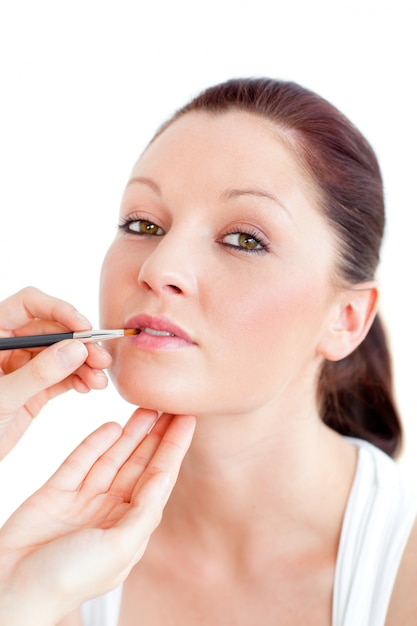 Portrait of a woman being made-up by a professional artist