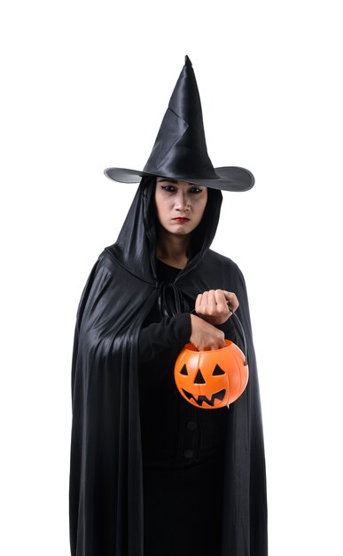 Portrait of woman in black Scary witch halloween costume standing with hat isolated
