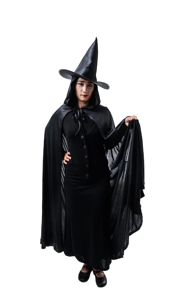 Portrait of woman in black Scary witch halloween costume standing with hat isolated