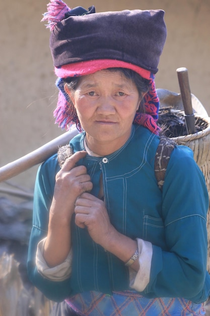 Portrait of woman carrying objects outdoors