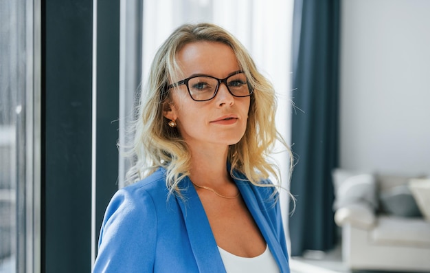 Portrait of woman in casual clothes that standing indoors at home