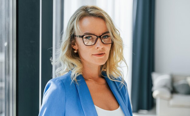 Portrait of woman in casual clothes that standing indoors at home