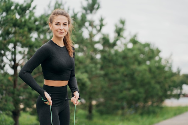 Portrait of a woman of Caucasian appearance in black tight sports comfortable clothing