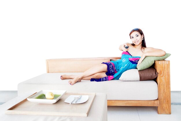 Photo portrait of woman changing tv channel on sofa