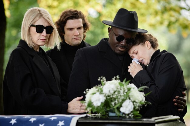 Portrait of woman crying at outdoor funeral ceremony and wearing black copy space