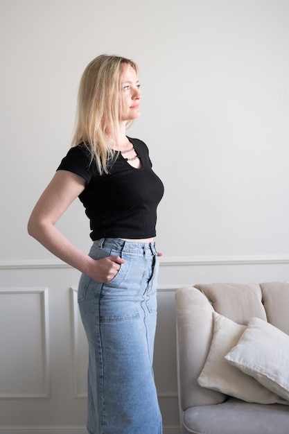 Portrait of a woman in a denim skirt.