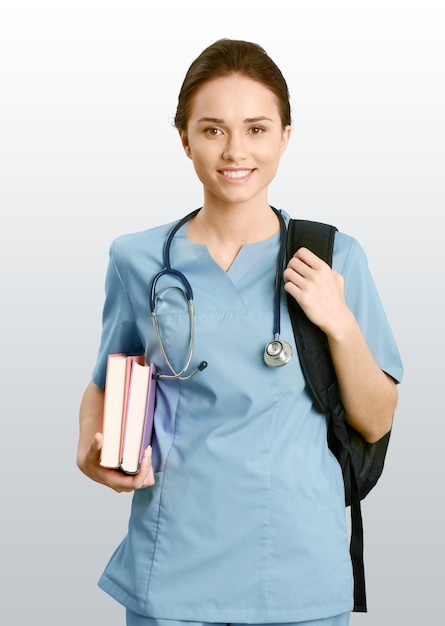 Portrait of woman doctor with books