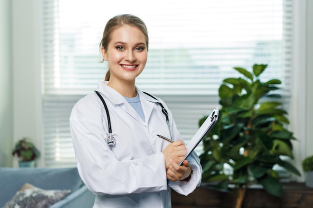 Portrait of a woman doctor with stetoscope looking at camera smiling female doctor in a clinic