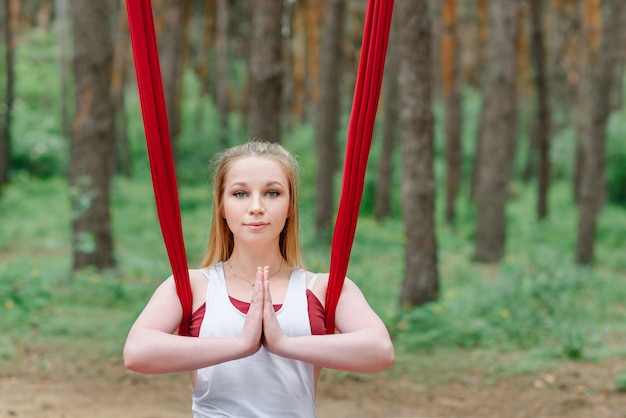 Portrait of a woman doing yoga in the forest.