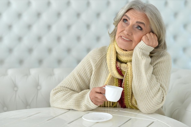 Portrait of a woman drinking coffee, thinking about something