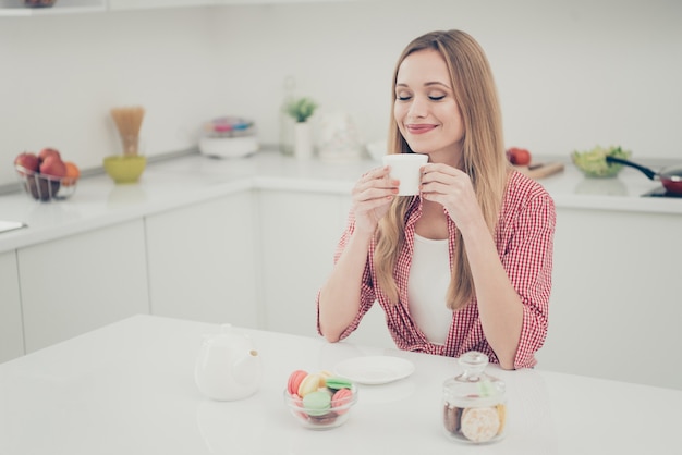 portrait woman drinking tea and eating macaroons