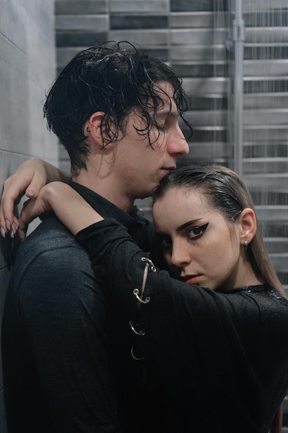 portrait of woman embracing male partner in shower