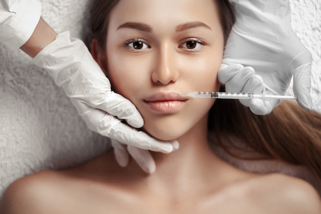 Portrait of woman getting cosmetic injection