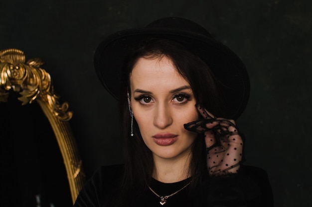 Portrait of a woman in gloves on a black background