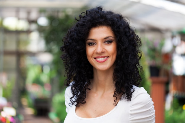 Portrait of a woman in a greenhouse