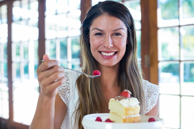 Portrait of woman having a pastry in restaurant