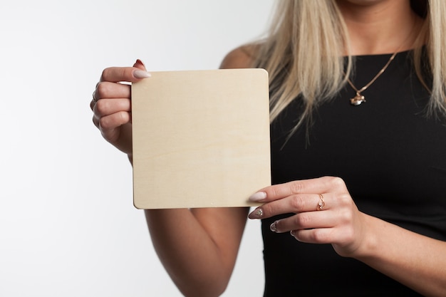 Portrait of a woman holding a blank paper