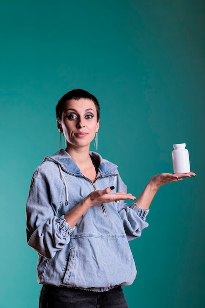 Photo portrait of woman holding bottle of painkiller showing at camera after receiving health care                               person