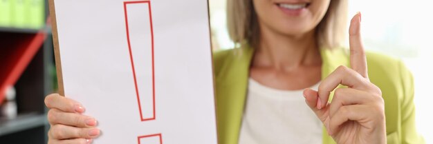 Portrait of woman holding clipboard with red exclamation point interjection and exclamatory