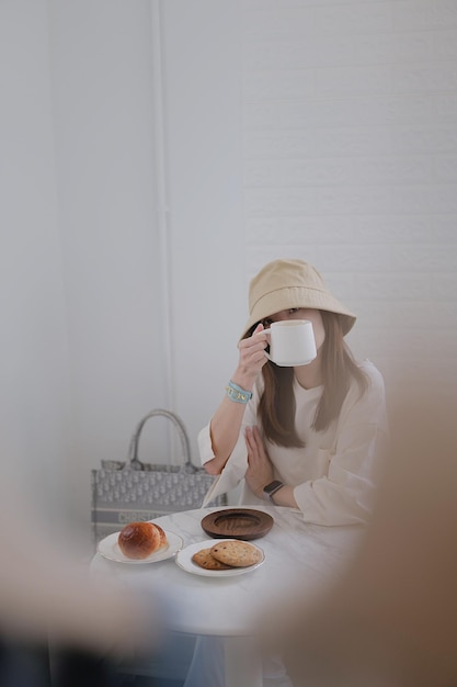 Photo portrait of woman holding coffee cup sitting at cafe