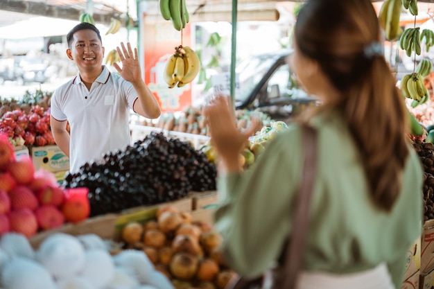 Photo portrait of woman holding fruits at market