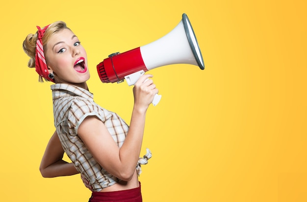 Portrait of woman holding megaphone, dressed in pin-up style