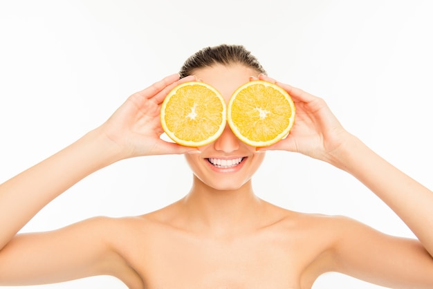 Portrait of woman holding orange slices