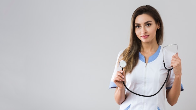 Portrait of woman holding a stethoscope with copy space