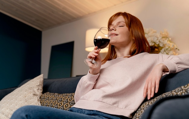 Portrait woman at home relaxing with glass of wine