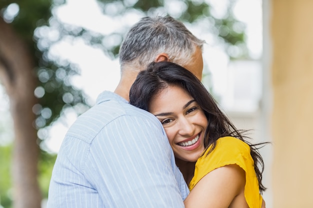 Portrait of woman hugging man