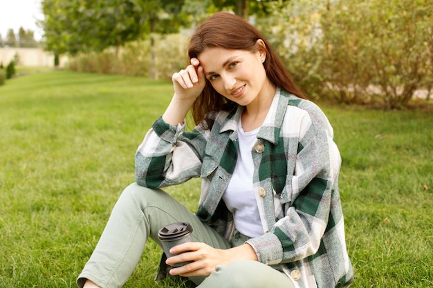 Portrait of a woman on the lawn on a walk in early autumn