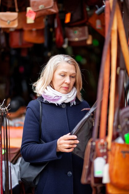 Portrait of a woman in a leather bag shop.