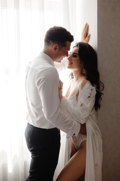 portrait of a woman in lingerie and a man in a white shirt man woman love each other