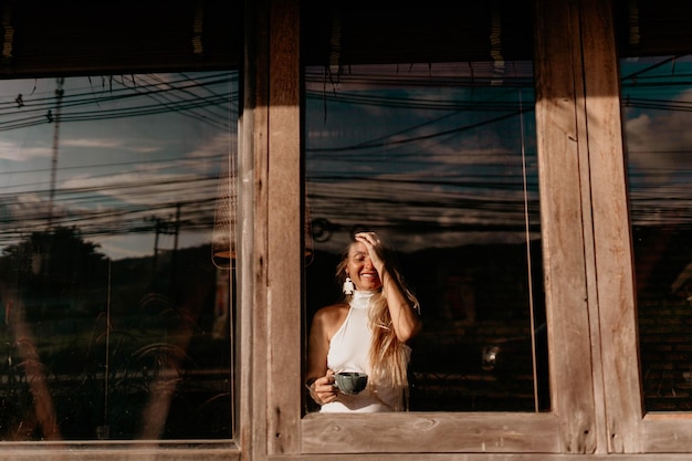 Portrait of woman looking through window