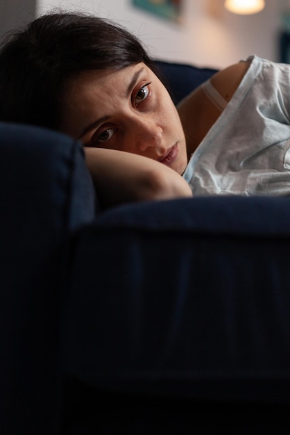 Portrait of woman lying on bed