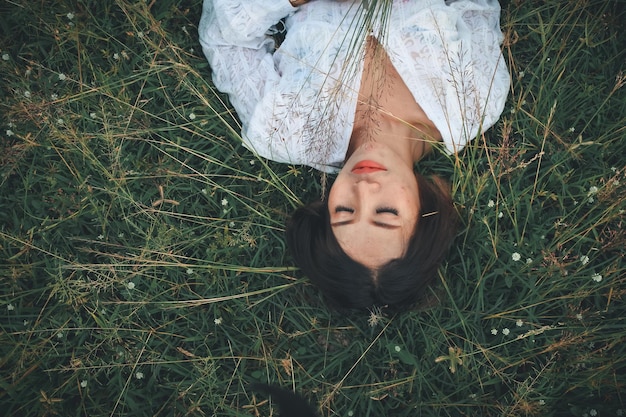 Portrait of woman lying on field