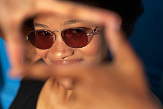 Portrait of woman making a camera frame with hands