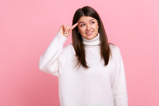 Photo portrait of woman making stupid sign with finger near head gesturing bad mind dumb insane idea