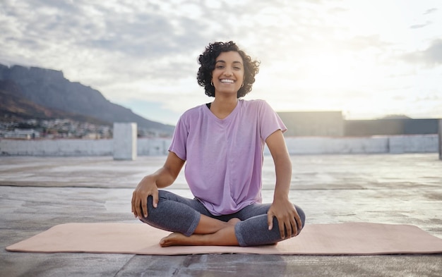 Portrait of woman meditation while training yoga exercise outdoor in a city Young zen female athlete workout and finding peace balance and wellness and healthy while happy about fitness lifestyle