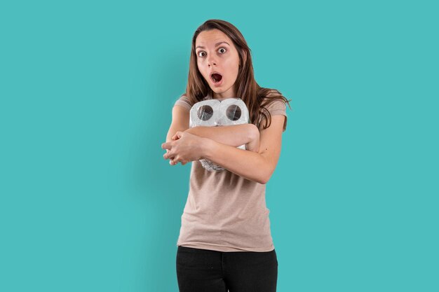 Portrait of woman photographing against blue background