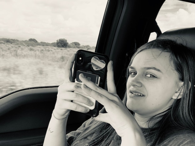 Photo portrait of woman photographing car