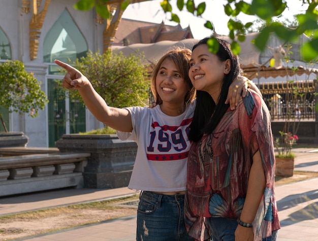 Photo portrait of woman photographing with mobile phone outdoors