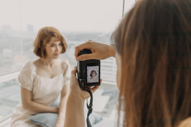 Portrait of woman photographing with mobile phone