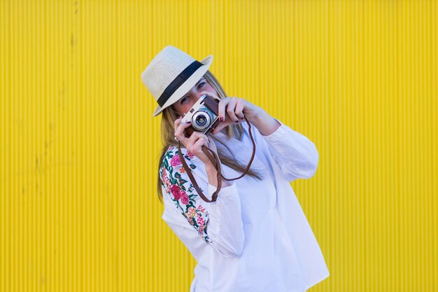 Photo portrait of woman photographing with yellow umbrella