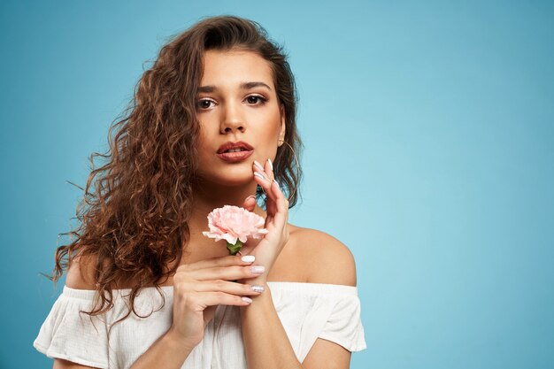 Portrait of woman posing with flower