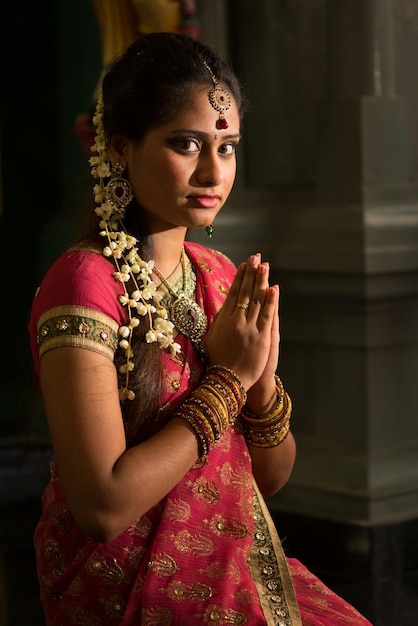 Portrait of woman praying in temple